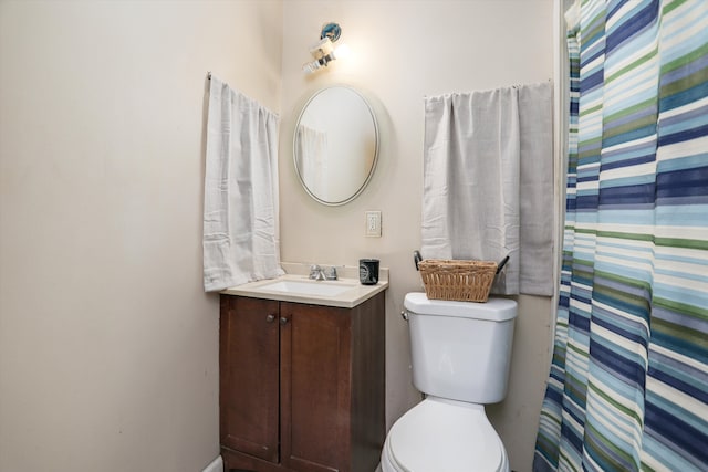 bathroom featuring walk in shower, vanity, and toilet