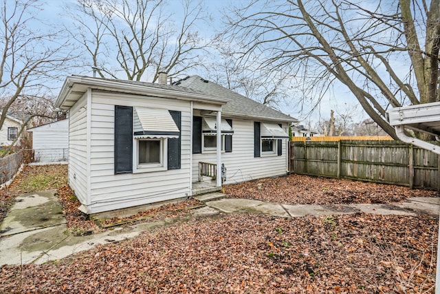 17300 Northrop St, Detroit, MI 48219 - back of property featuring a fenced backyard, a chimney, and a shingled roof
