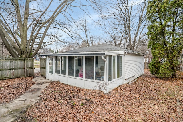 back of property with a sunroom