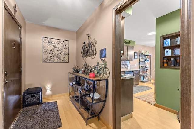 hallway with light hardwood / wood-style flooring