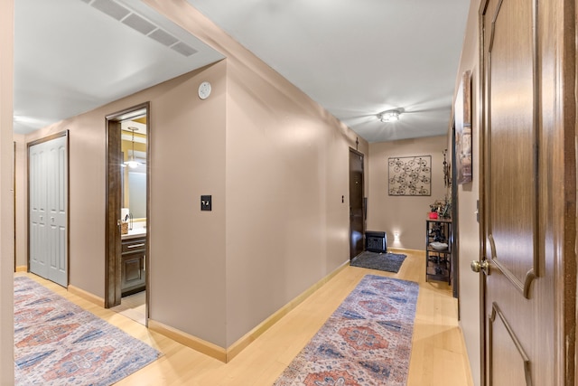 corridor featuring light hardwood / wood-style floors