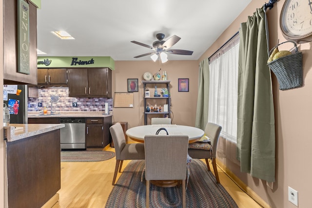 dining space featuring ceiling fan, light hardwood / wood-style floors, and sink