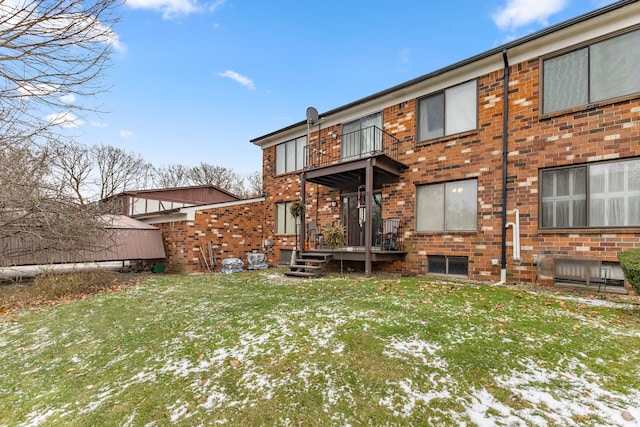 snow covered property featuring a yard and a balcony