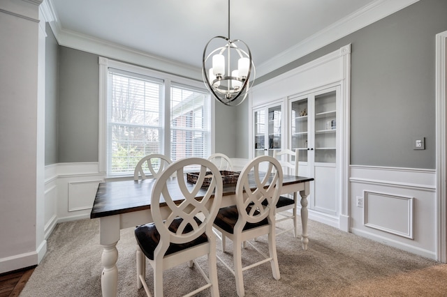 carpeted dining area with ornamental molding and a notable chandelier