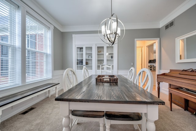 carpeted dining room featuring crown molding and a notable chandelier