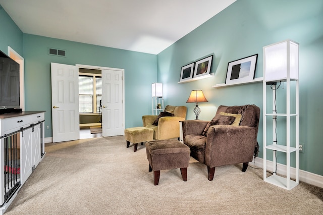 living area with light carpet