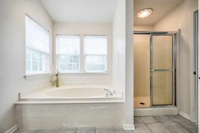 bathroom with tile patterned flooring and separate shower and tub