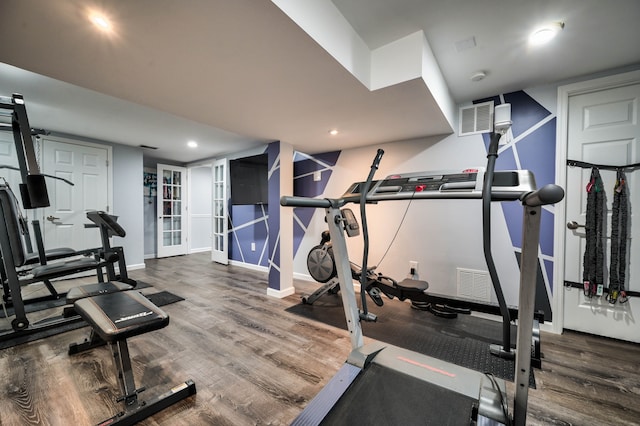 workout area featuring dark wood-type flooring