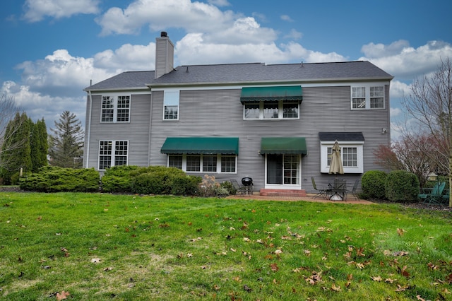 rear view of property with a lawn