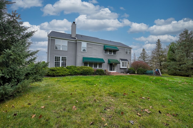 rear view of house with a lawn