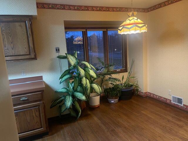 dining space with dark hardwood / wood-style flooring