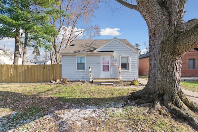 bungalow-style home featuring a front yard