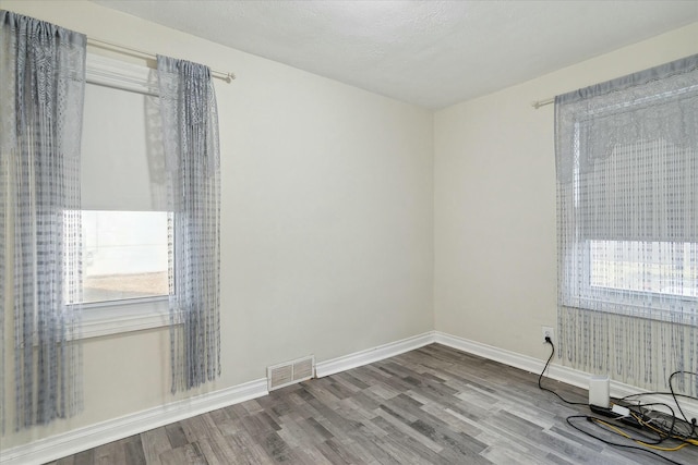 spare room with hardwood / wood-style floors