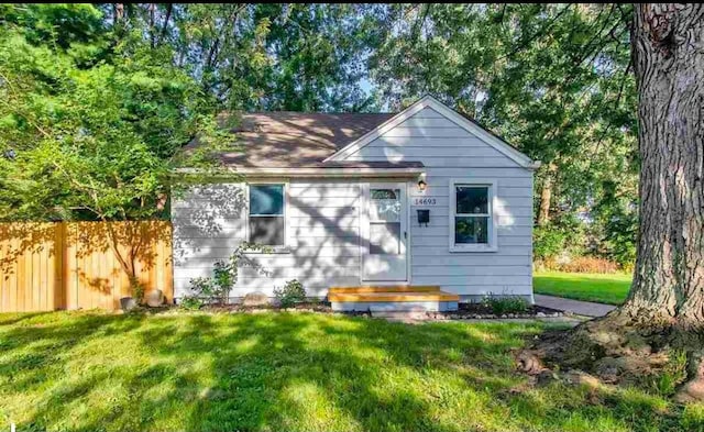 rear view of house with a yard