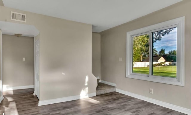 unfurnished room featuring dark hardwood / wood-style flooring