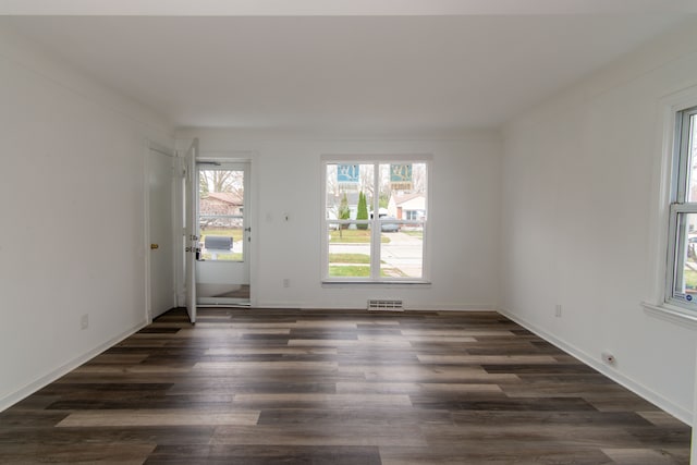 empty room featuring dark hardwood / wood-style flooring