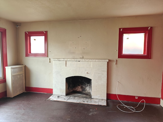 unfurnished living room with a brick fireplace