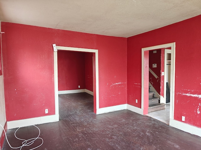 unfurnished room with a textured ceiling