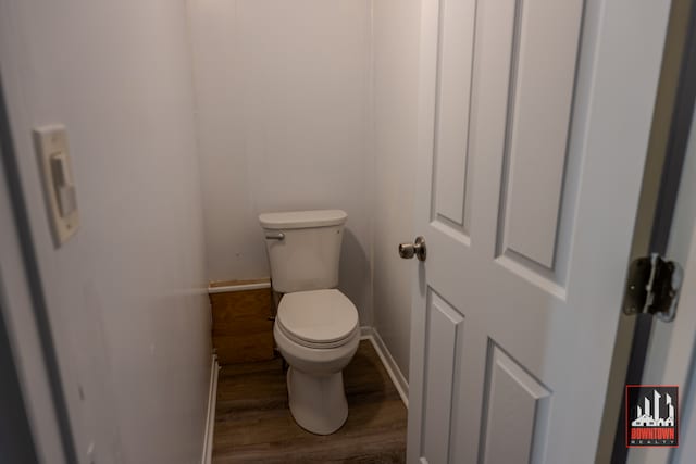 bathroom featuring toilet and wood-type flooring