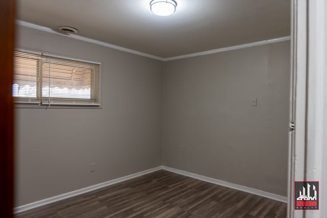 spare room with dark hardwood / wood-style floors and ornamental molding