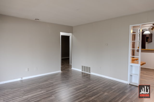 empty room featuring ceiling fan and dark hardwood / wood-style floors