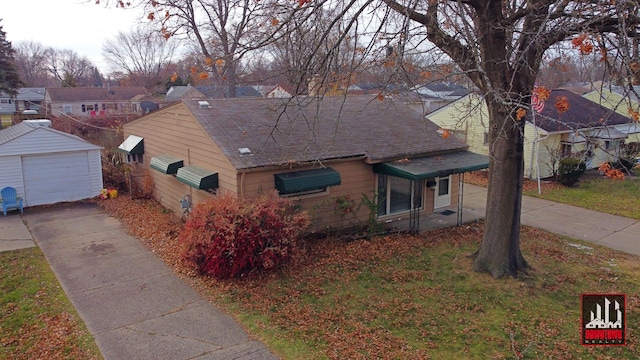 view of front of home featuring a garage and an outbuilding