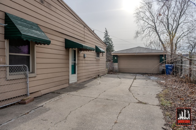 view of property exterior with an outbuilding and a garage