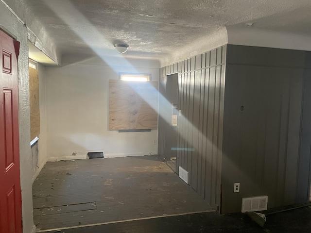 basement featuring a textured ceiling