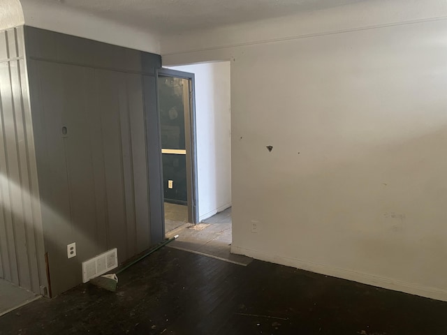 unfurnished room featuring wood-type flooring