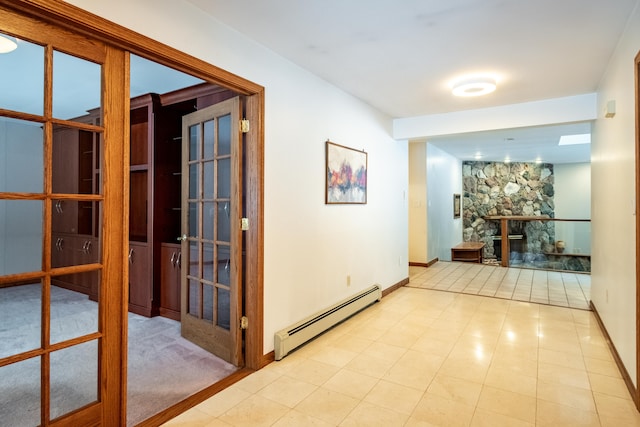 hallway with french doors, light tile patterned floors, and baseboard heating