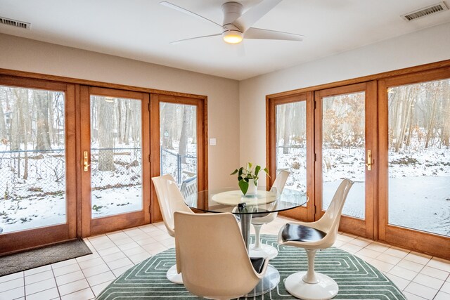 dining room featuring ceiling fan, light tile patterned flooring, and french doors