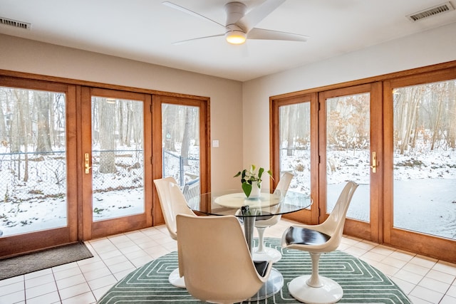 dining space with a ceiling fan, visible vents, and light tile patterned floors