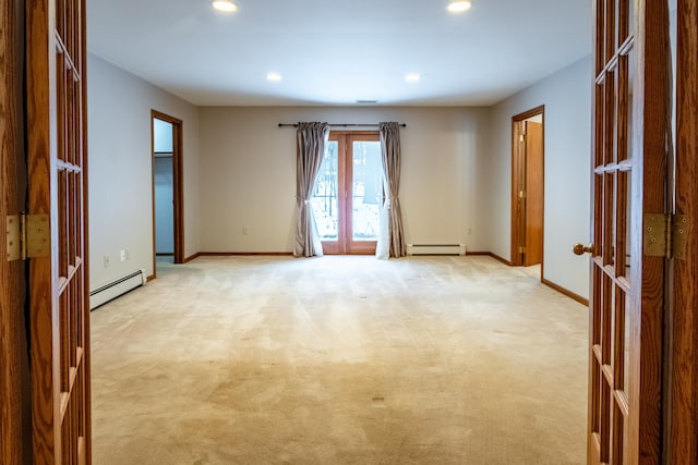 unfurnished room with french doors, baseboards, and a baseboard heating unit