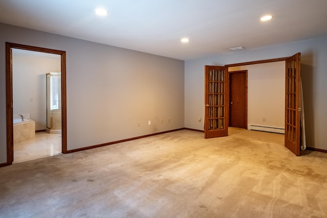 spare room with light colored carpet, visible vents, recessed lighting, baseboard heating, and baseboards