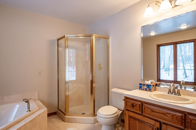 full bathroom with toilet, shower with separate bathtub, vanity, and tile patterned floors