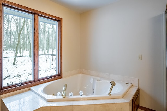 bathroom with a relaxing tiled tub