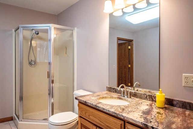 bathroom featuring toilet, a stall shower, tile patterned flooring, and vanity