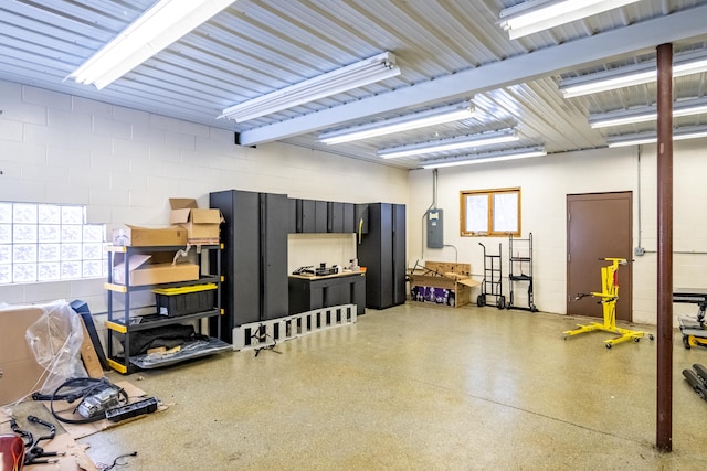 garage featuring electric panel and concrete block wall