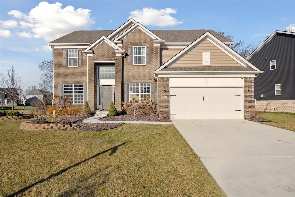 view of front of property with a garage and a front lawn