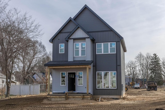 view of front of house with board and batten siding and fence