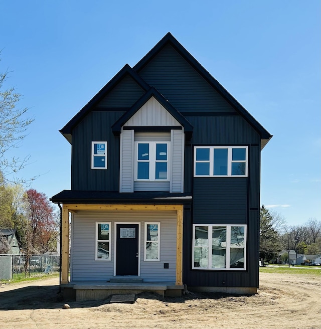 view of front of house featuring covered porch and fence