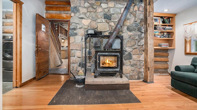 interior details featuring a wood stove and hardwood / wood-style floors