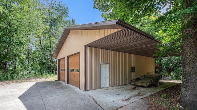 view of outdoor structure with a garage and a carport