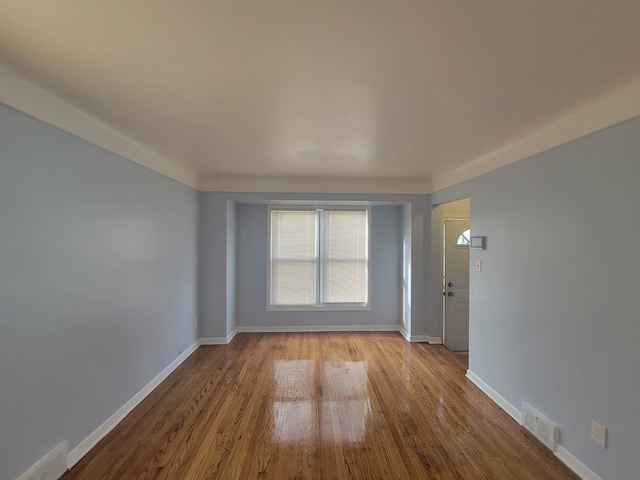 empty room with light hardwood / wood-style flooring