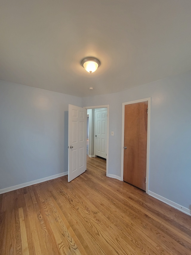 empty room with light hardwood / wood-style floors