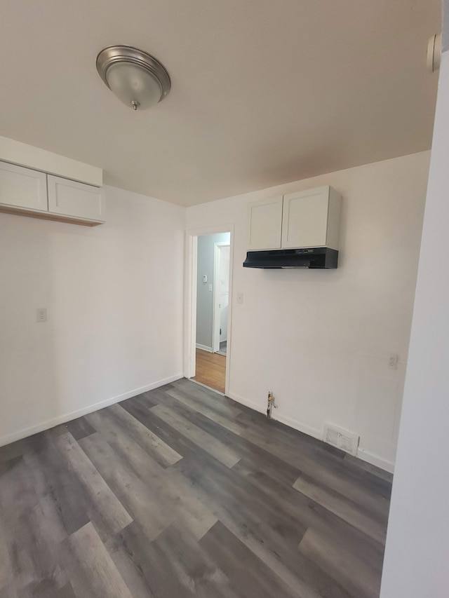 spare room with dark hardwood / wood-style flooring