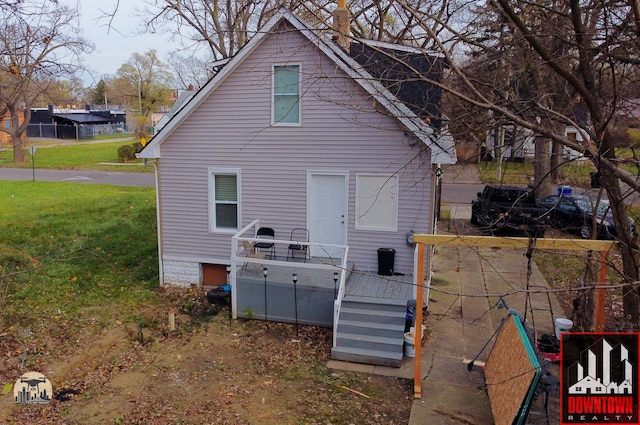 back of property featuring a yard