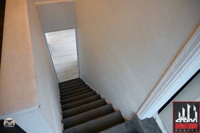 stairway featuring hardwood / wood-style floors