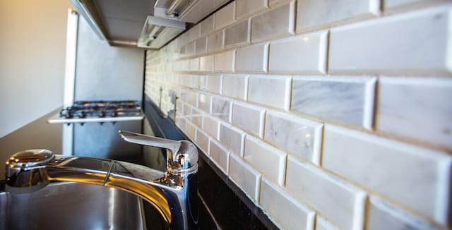 interior details featuring tasteful backsplash and sink