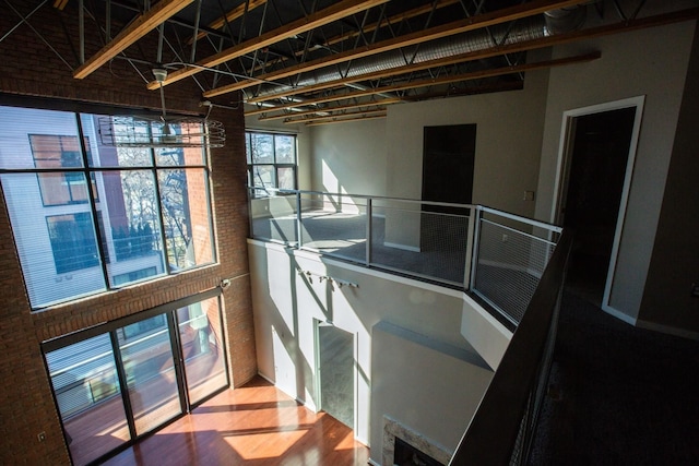 interior space featuring a towering ceiling and brick wall